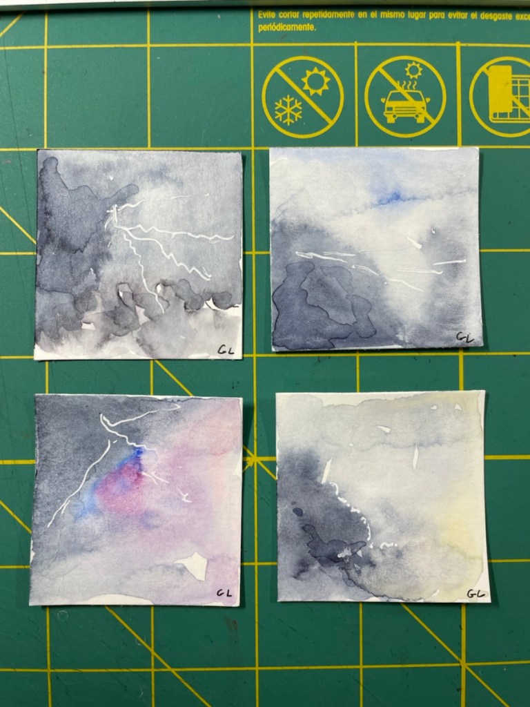 2x2 inch square of watercolors in Indigo, Ultramarine Blue, yellow and pink....abstract pieces of an early morning storm, white gel pen illustrating the lightning