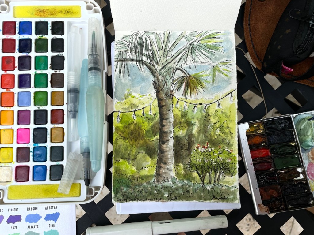 Plein air sketch with art supplie including a Stuart Semple watercolor palette.