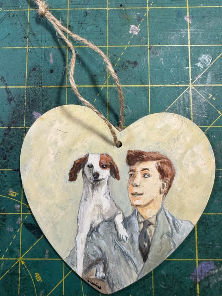 Small heart shaped painting of a young man and his dog.  Reference Photo from Museum App.  Art completed using Acrylic Gouache and colored pencil.